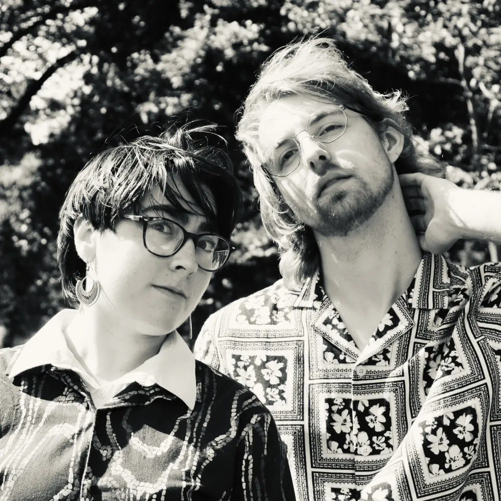 Black and white portrait of Bella and Mick in lovely patterned shirts, imitating the Bookends album cover